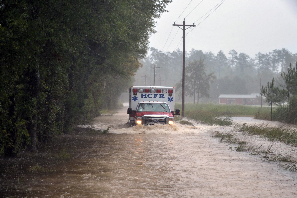 Soldiers with the 1-178th Field Artillery Battalion, South Carolina Army National Guard (ACNG) help escort Horry County Fire Rescue paramedics through flooded roads to reach someone in need of medical attention in Conway, S.C., during Hurricane Matthew, Friday, Oct. 8, 2016 | U.S. Air National Guard photo by Tech. Sgt. Jorge Intriago
