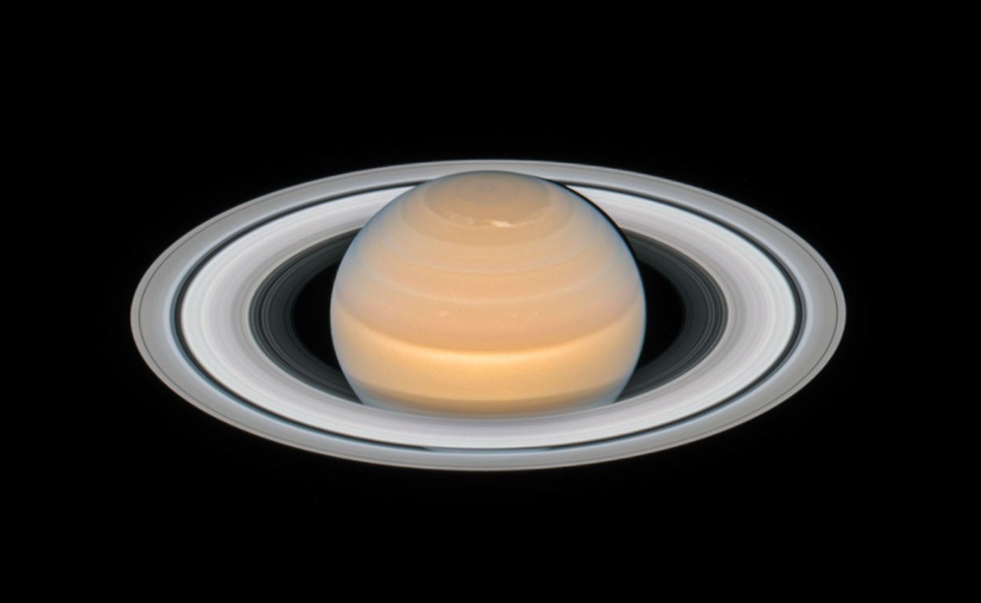 This time-lapse animation of Hubble observations shows the rotation of Saturn and six of its moons over roughly 20 hours. In a textbook demonstration of Keplerian motion, the moons closer to the planet orbit more rapidly, while those farther away move more slowly. | Credit: NASA, ESA, A. Simon (GSFC) and the OPAL Team, and J. DePasquale (STScI)
