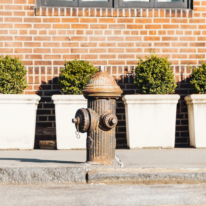fire hydrant against residential building. Photo Credit: freepik.com